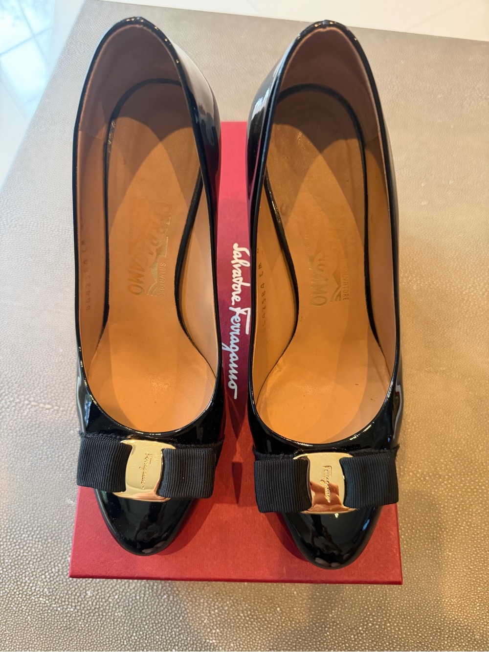 Salvatore Ferragamo Black Patent Vara Bow Pumps with Gold Plaque Accent
